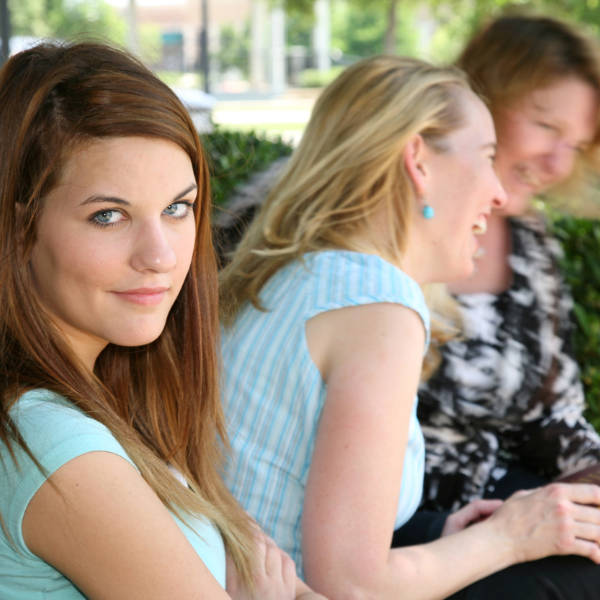 Women talking and one left out representing how pastors' wives can feel sometimes